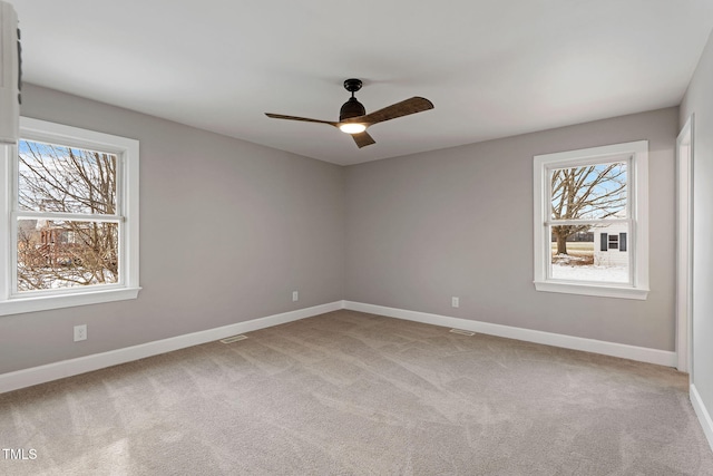 empty room with carpet flooring and ceiling fan