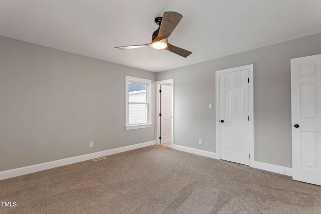 unfurnished bedroom with ceiling fan and carpet