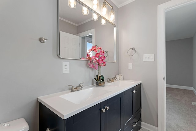 bathroom with crown molding, vanity, and toilet