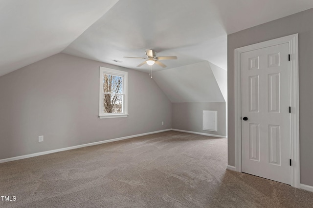 additional living space featuring ceiling fan, vaulted ceiling, and light carpet