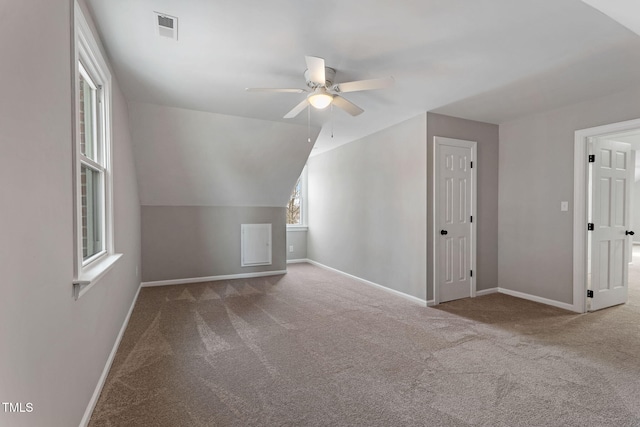 additional living space with ceiling fan, vaulted ceiling, and carpet