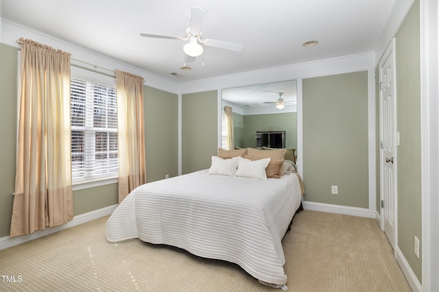 carpeted bedroom featuring crown molding and ceiling fan