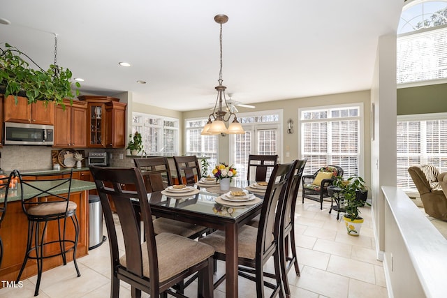 tiled dining space with a healthy amount of sunlight