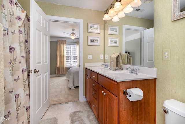 bathroom featuring tile patterned floors, vanity, and toilet