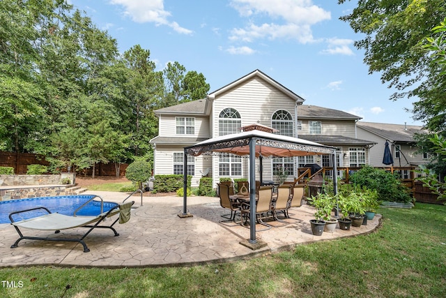 back of house with a lawn, a patio, a fenced backyard, a gazebo, and an outdoor pool