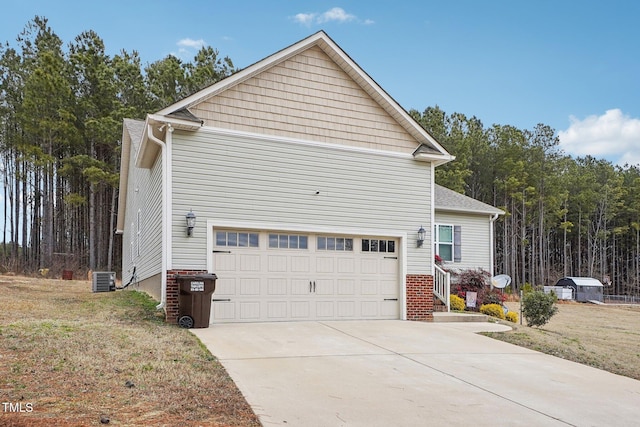 view of home's exterior with a garage, a yard, and central air condition unit