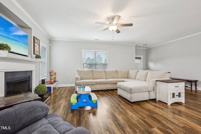 living room featuring dark wood-type flooring, ornamental molding, and ceiling fan