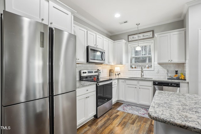 kitchen featuring decorative light fixtures, sink, white cabinets, stainless steel appliances, and light stone countertops