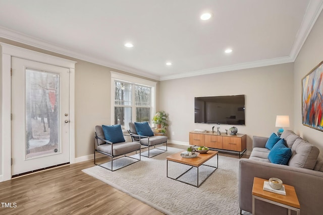 living room with hardwood / wood-style flooring and ornamental molding