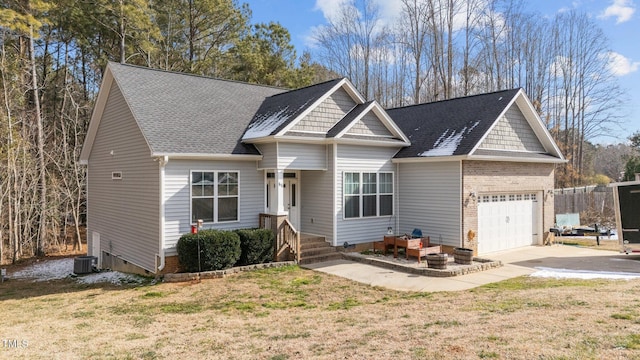 view of front of home with a garage and a front lawn