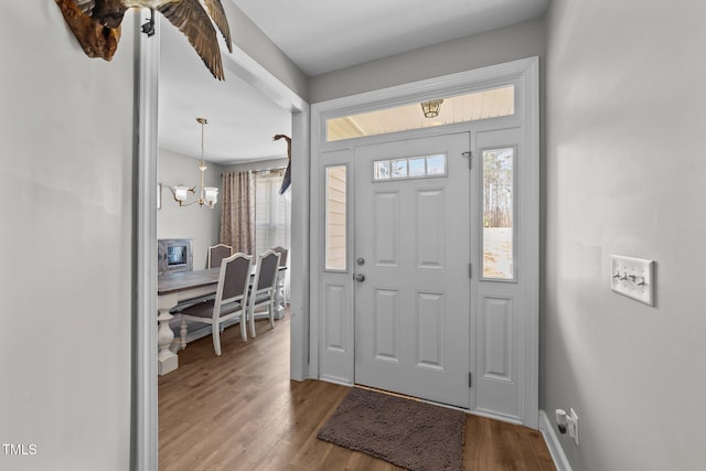 foyer entrance featuring a chandelier and hardwood / wood-style floors