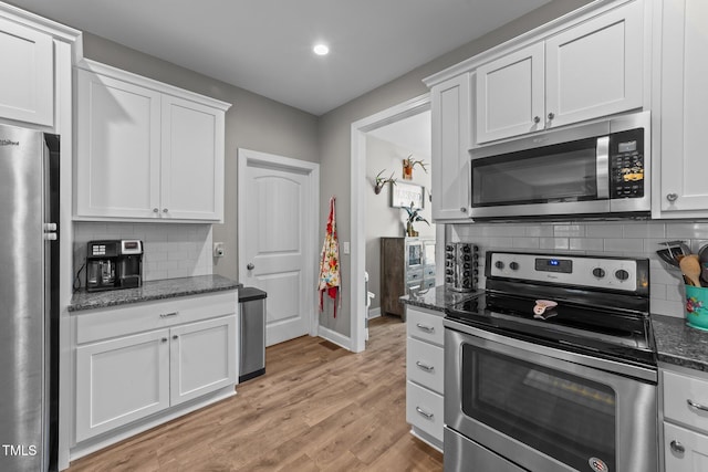 kitchen with white cabinetry, tasteful backsplash, and stainless steel appliances