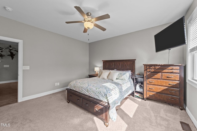 bedroom with light carpet and ceiling fan