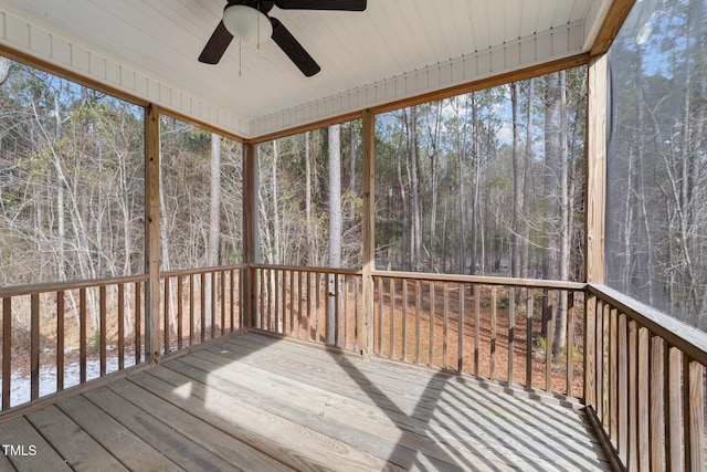 unfurnished sunroom featuring ceiling fan