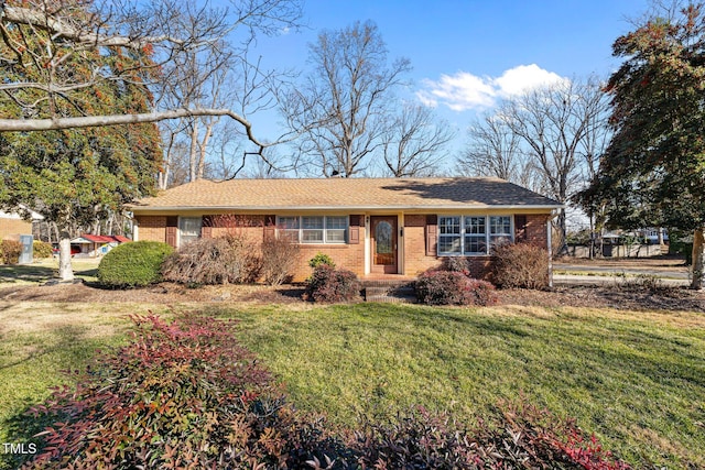 single story home featuring a front lawn