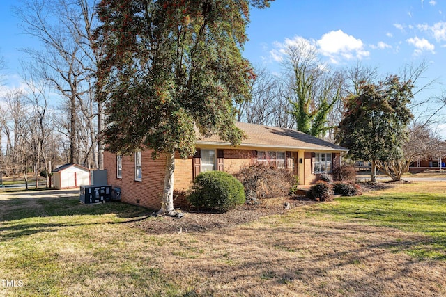 view of side of property with a storage shed and a yard