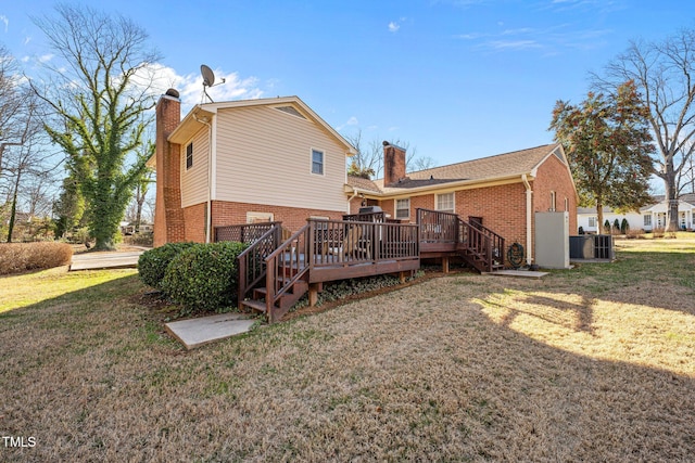 back of property with central AC unit, a yard, and a deck