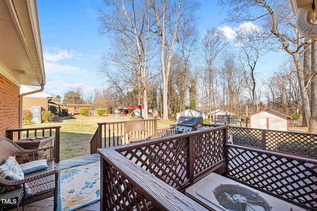 wooden deck featuring area for grilling, central AC, and a yard