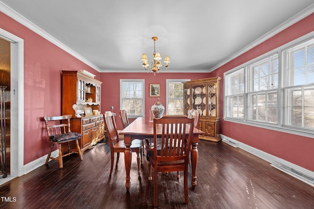 dining area with ornamental molding, dark wood-type flooring, and an inviting chandelier