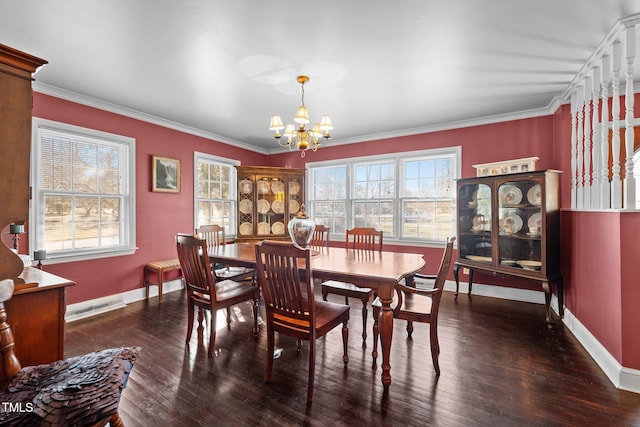 dining area with an inviting chandelier, crown molding, and dark hardwood / wood-style flooring