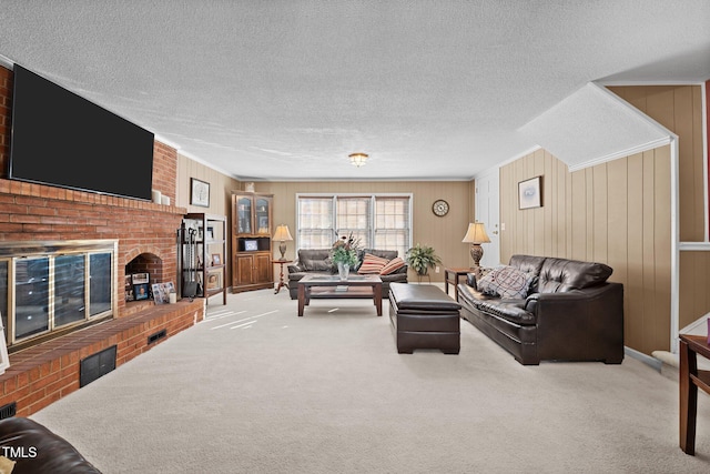 carpeted living room with a textured ceiling and a fireplace