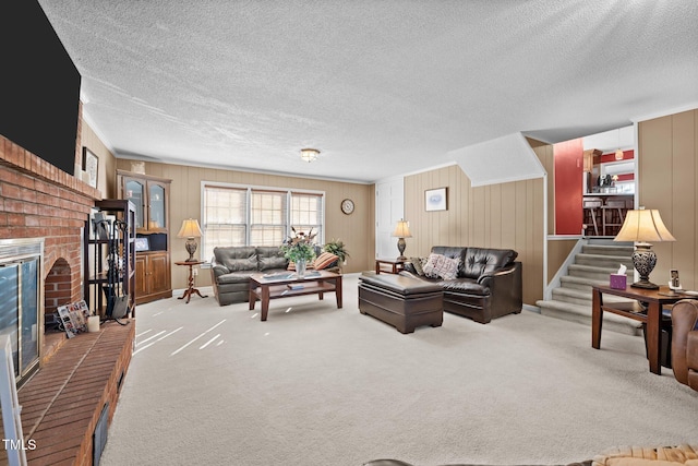 carpeted living room with a fireplace and a textured ceiling