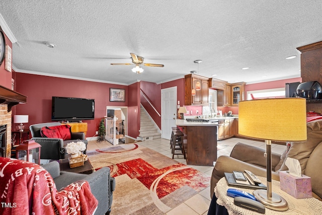 living room featuring light tile patterned flooring, ceiling fan, and crown molding