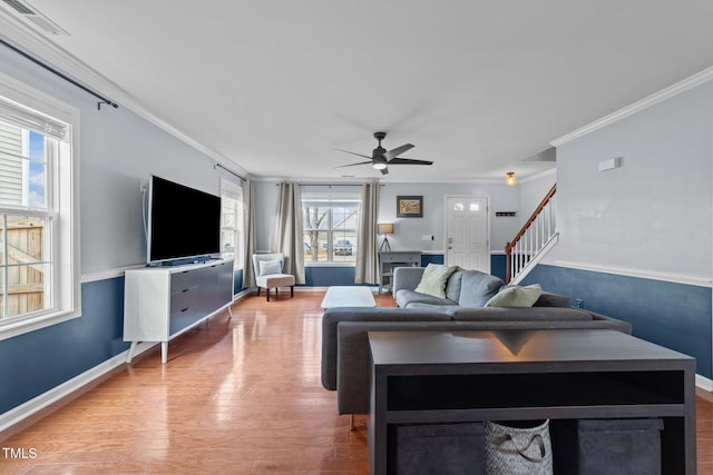 living room with crown molding, ceiling fan, and light wood-type flooring