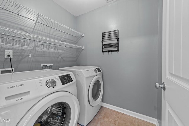 clothes washing area with washer and clothes dryer