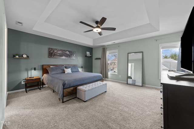 bedroom featuring carpet flooring, ceiling fan, and a tray ceiling