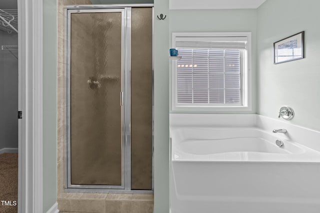 bathroom with shower with separate bathtub