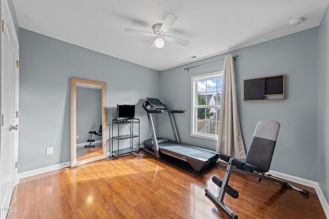 exercise room with hardwood / wood-style floors and ceiling fan