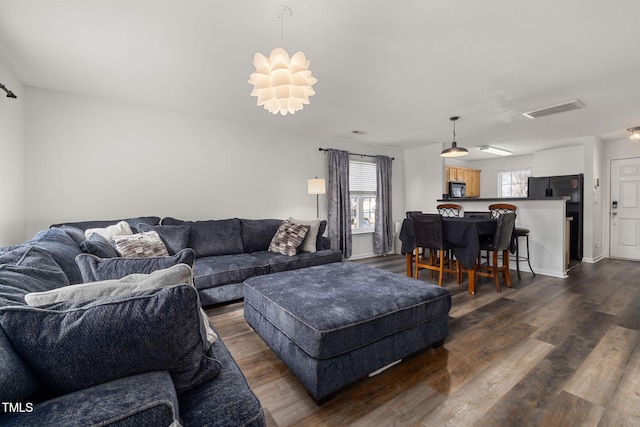 living room with dark hardwood / wood-style flooring