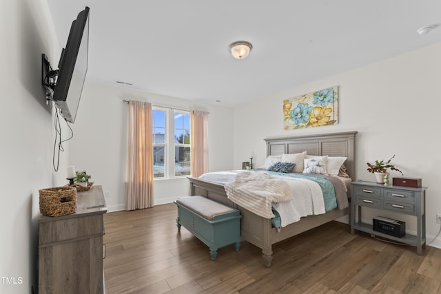 bedroom with dark wood-type flooring