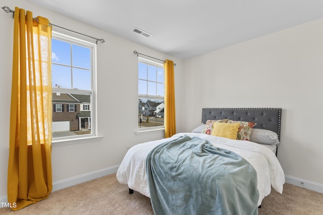 bedroom featuring light colored carpet