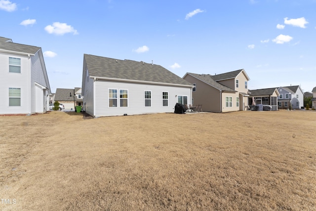 back of house with a lawn