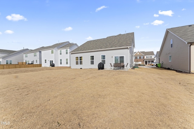 rear view of property with a lawn and a patio area