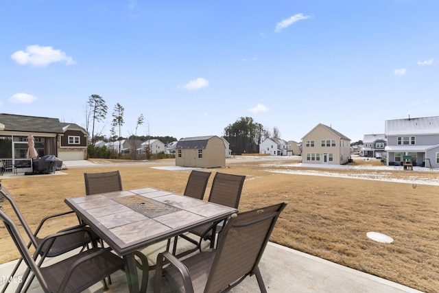 view of patio featuring a storage unit