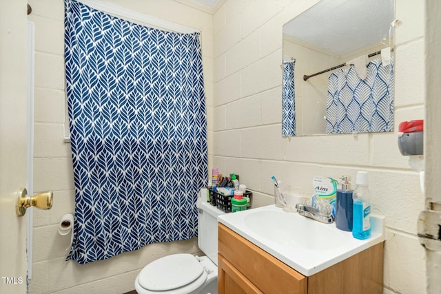 bathroom with toilet, vanity, crown molding, and walk in shower