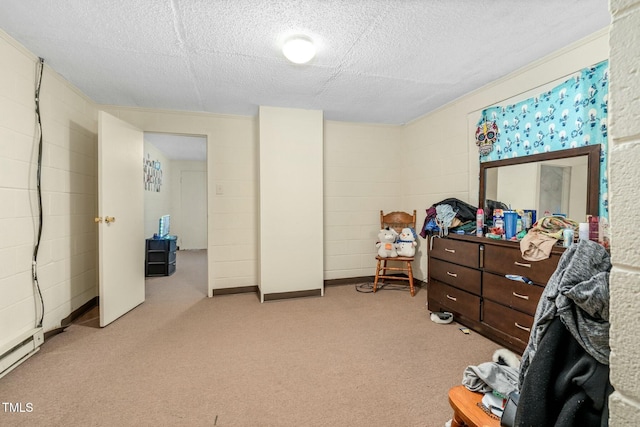 bedroom with light carpet, a textured ceiling, and a baseboard heating unit