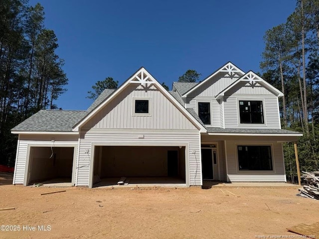 199 Pinecrest Dr, Carthage, NC 28327 - view of front of home featuring board and batten siding, a garage, and a shingled roof