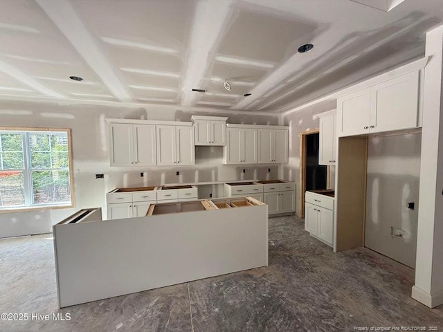 199 Pinecrest Dr, Carthage, NC 28327 - kitchen featuring a kitchen island, coffered ceiling, and white cabinets