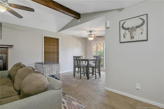 carpeted living room featuring ceiling fan and lofted ceiling with beams