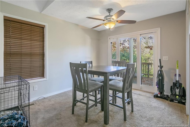 carpeted dining space featuring ceiling fan