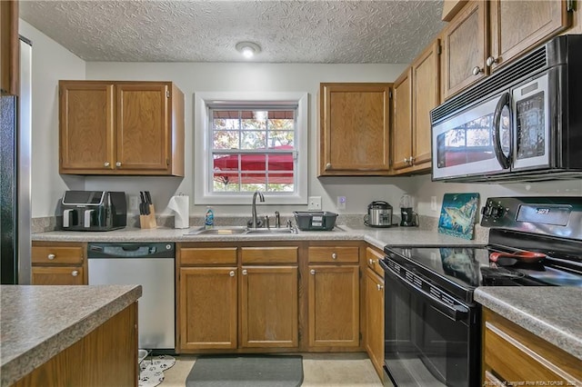 kitchen featuring sink, a textured ceiling, and black appliances