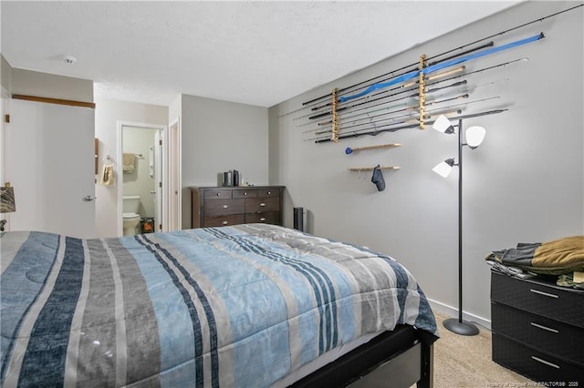 carpeted bedroom featuring ensuite bath