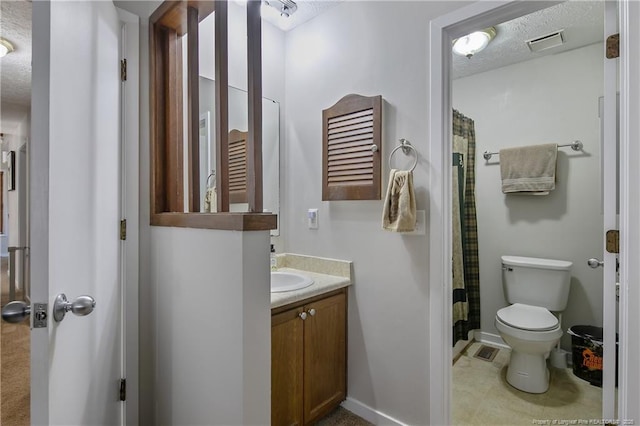 bathroom featuring a textured ceiling, toilet, vanity, and a shower with curtain