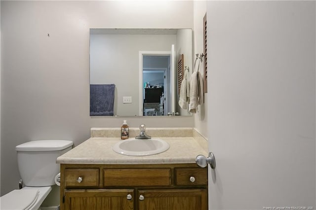 bathroom featuring toilet and vanity