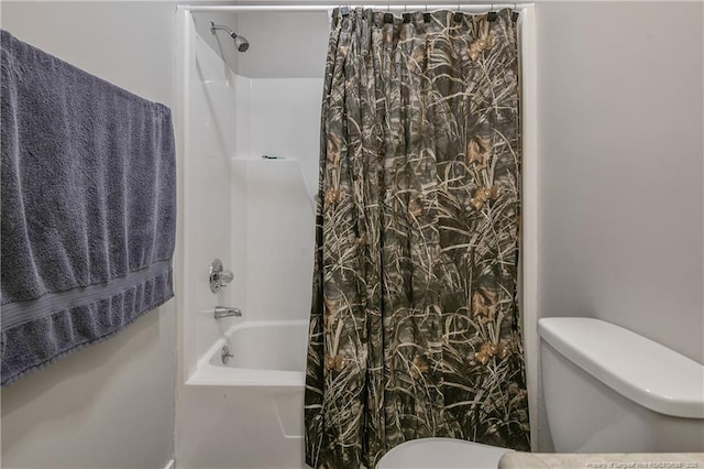 bathroom with toilet and shower / bath combination with curtain