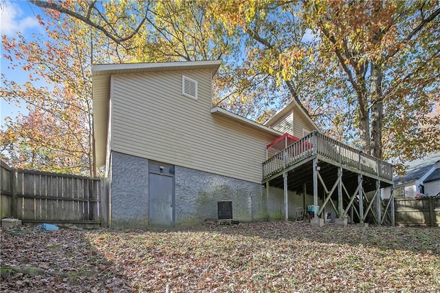 back of house with a deck